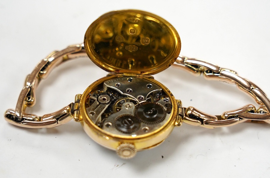 A lady's early 20th century 9ct gold manual wind wrist watch, with Arabic dial, on a 9ct expanding bracelet, gross weight 21.7 grams. Condition - fair to good